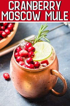 cranberry moscow mule in a copper mug with lime and rosemary garnish