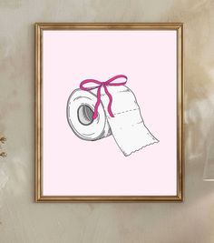 a pink poster with a roll of toilet paper tied to it's side in front of a white wall