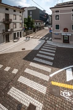 an empty street with people walking on it