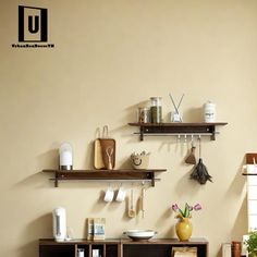 a room with shelves, pots and utensils on the wall next to each other