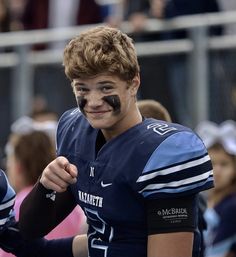 a young man with his face painted like a football player