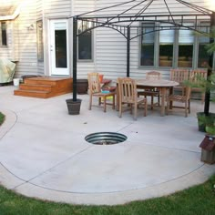 a patio with a table and chairs under an umbrella