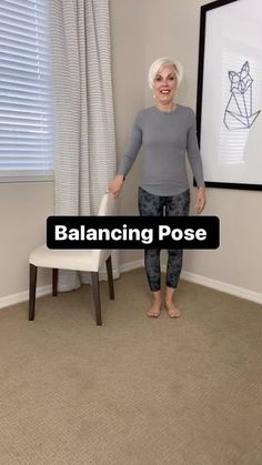 an older woman standing in front of a chair with the words balancing pose on it