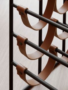 a close up of a metal rack with leather straps