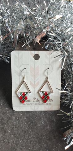 I suppose these don't necessarily have to be for the holidays but that was what I had intended them for! Admittedly I started listening to holiday music even before Thanksgiving. I refuse to decorate till at least December but you betcha I appreciate those who get into the holiday spirit early. Woven onto silver plated triangles and finished with sterling silver ear wires. Classic red and white and a pop of matte glazed green make up these tiny cuties. Handwoven Earrings, Pendulum Earrings, Earrings Triangle, Beaded Beads, Hammered Hoop Earrings, Brick Stitch Earrings, Holiday Music, Rose Gold Studs, Bead Ideas