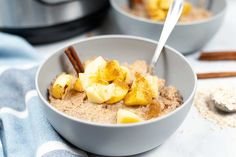 two bowls filled with oatmeal and cinnamon on top of a blue towel