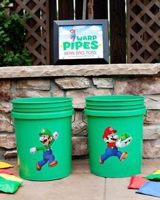 two green pails with mario bros pictures on them