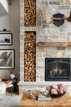 a living room filled with furniture and a fire place next to a wall mounted fireplace