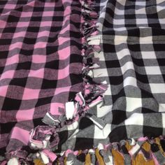 a black and white checkered blanket with ruffles on the edges is laying down