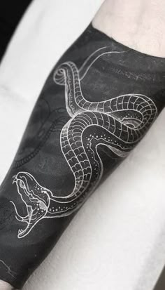 an arm with a snake tattoo on it