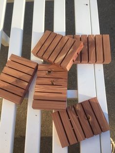 several pieces of wood sitting on top of a white bench