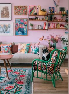 a living room filled with furniture and lots of pictures on the wall above it's couch