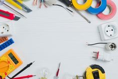 various electrical tools arranged in a circle on a white table with space for text or image