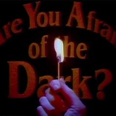 a hand holding a matchstick with the words are you afraid of the dark?