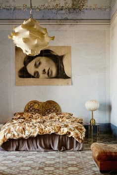 a bed sitting under a painting on the wall