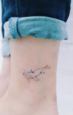 a small whale tattoo on the ankle