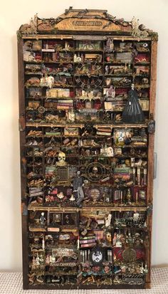 an old wooden bookcase with many different items on it's sides and shelves