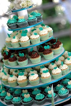 cupcakes are stacked on top of each other in the shape of a tree