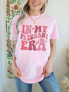 Pregnant Mom Shirt, Mother to Be Shirt, In My Pregnancy Era, New Mom Shirt, Pregnant Mom Gift, Comfort Colors®, In My Mom Era Shirt  F I T ∙ & ∙ S I Z I N G : -->These Unisex T-shirts have a modern-fit. Consult the size chart in the pics for an accurate fit. -->Women's sizes are narrower than the waist. -->Sleeves are rolled up in some product pictures. They do not come rolled up on delivery. T I M E ∙ T O ∙ D E L I V E R Y : -->Processing and production time is 1-2 business days. -->Delivery ti Cute Maternity T-shirt With Letter Print, Pink Cotton Maternity Top, Pink Tops With Funny Text For Gender Reveal, Maternity Short Sleeve Top With Letter Print, Maternity Tops With Letter Print And Short Sleeves, Pink Tops With Funny Print For Gender Reveal, New Mom Shirts, Pregnant Mom Gifts, In My Mom Era