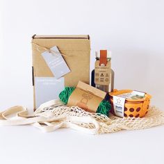 an assortment of items sitting on top of a white cloth next to a brown bag