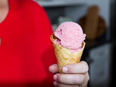 a woman holding an ice cream cone in her hand