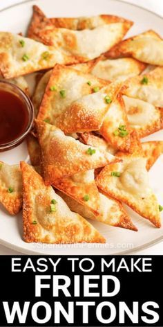 fried wontons on a plate with dipping sauce