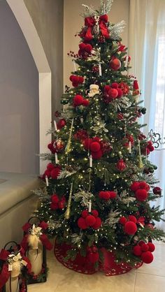 a christmas tree decorated with red and silver ornaments