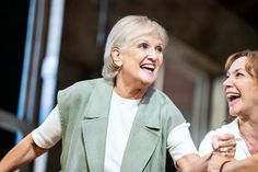 two women are dancing together on stage