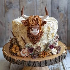 a cake decorated with flowers and an animal head