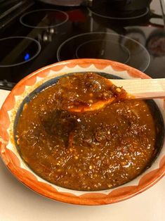 a bowl filled with food sitting on top of a stove