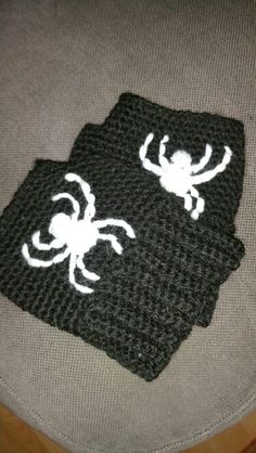 two crocheted spider coasters sitting on top of a chair with white thread