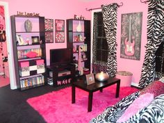 a living room with zebra print furniture and pink carpeted walls in the corner, along with bookshelves