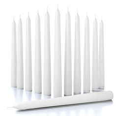 several white candles lined up next to each other