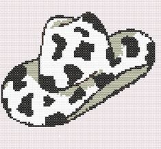 a cross stitch pattern of a cow's head in black and white on a pink background