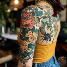 a woman with tattoos on her arms and shoulder