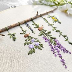 a close up of a cross stitch with flowers on it