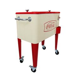 an old style cooler on wheels with the coca cola logo painted on it's side