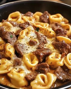 a skillet filled with pasta and beef