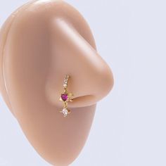 a close up view of an ear with a ring on it's side and two diamonds in the middle