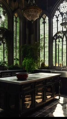 a kitchen with large windows and an island in front of the stove top ovens