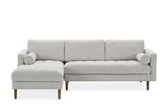 a white couch with a footstool sitting next to it