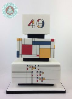 a white cake with multicolored squares and numbers on it