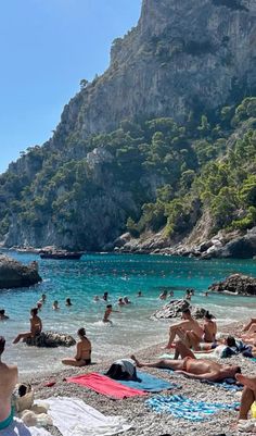 many people are on the beach and in the water