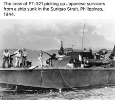 the crew of pt - 32 picking up japanese survivor from a ship sunk in the surga strait, philippines, 1940