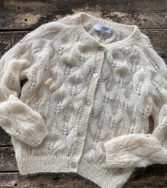 "Alpaca and silk openwork woman cardigan with shell buttons.  Warm and soft-touch it will be perfectly for a your basic outfit!  Very delicate and feminine, it will complement any of your outfits and make it chic. Product Details: * 75% alpaca, 25% silk Size S:  Width : 46/48 cm Length: 56 cm Size M:  Width : 50/52 cm Length: 60 cm  Size L:  Width : 54 cm Length: 60 cm Size XL:  Width : 56/58cm Length: 65 cm If you would like me in other size, you could request a custom order with your own param Elegant Mohair Cardigan For Layering, Elegant Cream Open Knit Cardigan, Elegant Hand Knitted Winter Cardigan, Elegant Mohair Cardigan, Elegant Fitted Mohair Cardigan, Elegant Hand Knitted Long Sleeve Cardigan, Elegant Hand Knitted Fitted Sweater, Elegant Fitted Hand-knitted Sweater, Elegant Fitted Hand Knitted Sweater