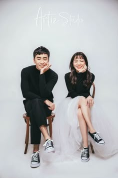 two people sitting next to each other in front of a white background with the words artie studio on it