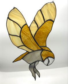 a stained glass bird hanging from the ceiling