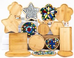 a bunch of wooden pieces with different designs on them, including plates and trays