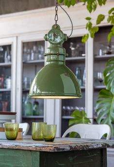 a green light hanging over a wooden table