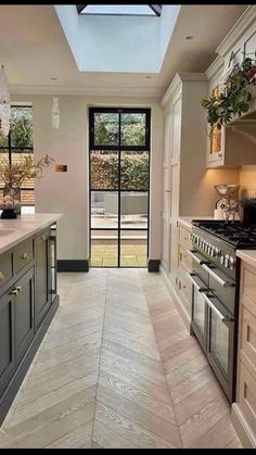 a kitchen with an open skylight above the stove and counter top area is shown